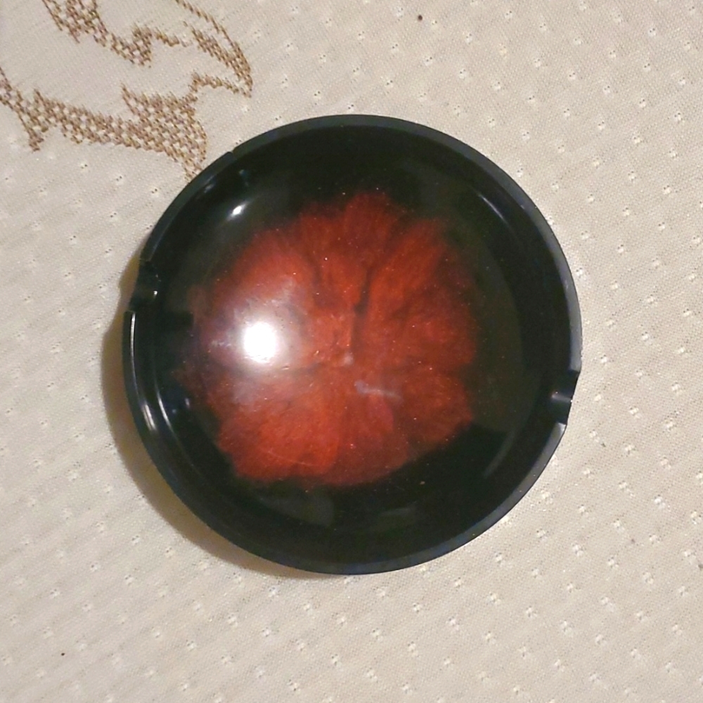 Homemade red and black ashtray